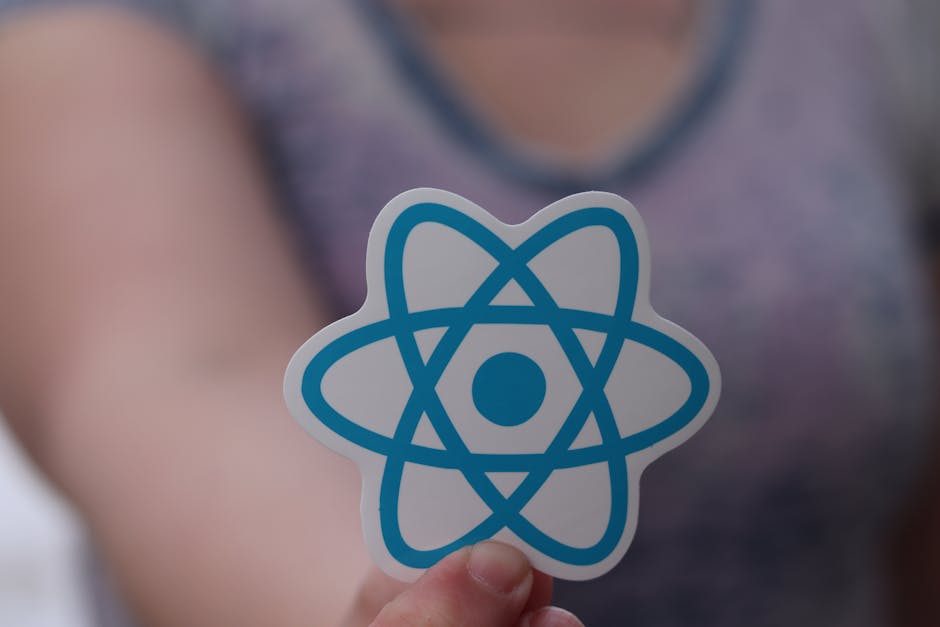 A close-up view of a hand holding a rectangular sticker with a white background. The sticker displays three black horizontal lines resembling a computer code or programming symbol, followed by the tex